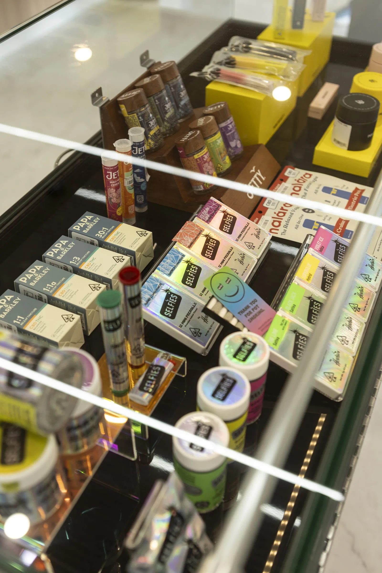 A lit La Flōr display case of curated products.